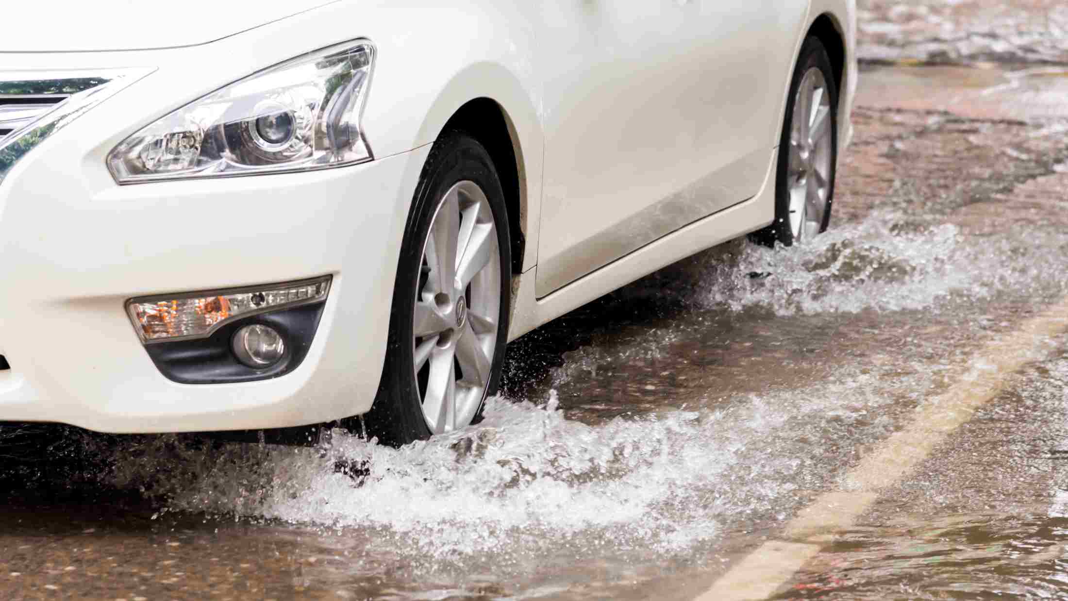 Low view of car driving o a flooded road